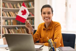 Canadian girl smiling with pick a canada flag