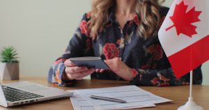 Canada’s 2025 Skilled Migration Surge: What Applicants Need to Know 2 canadian woman consular officer giving passport male immigrant work visa citizenship visa application online form immigration concept visa approval