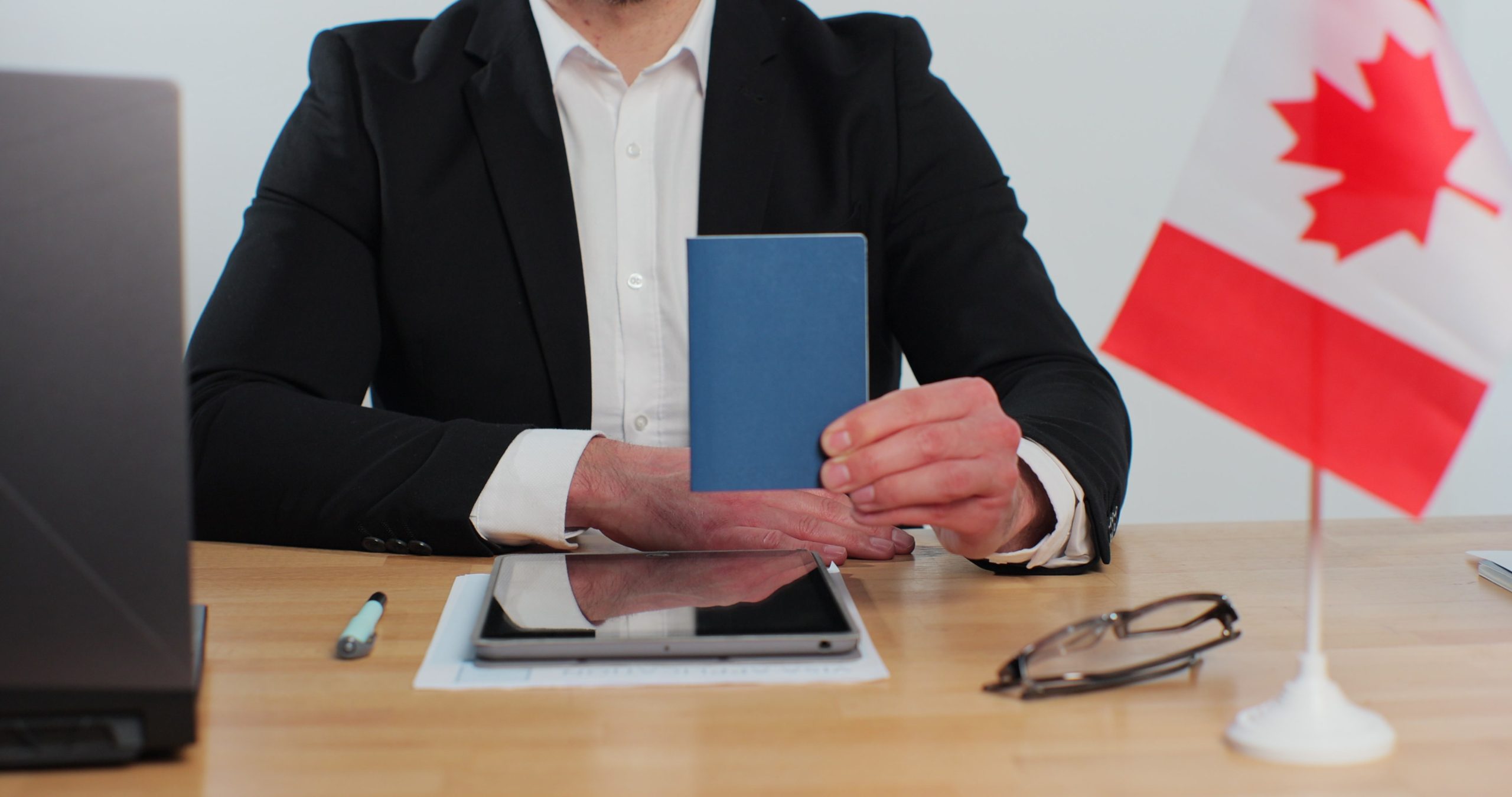 Canadian man consular officer showing passport immigrant, work visa, citizenship. 
