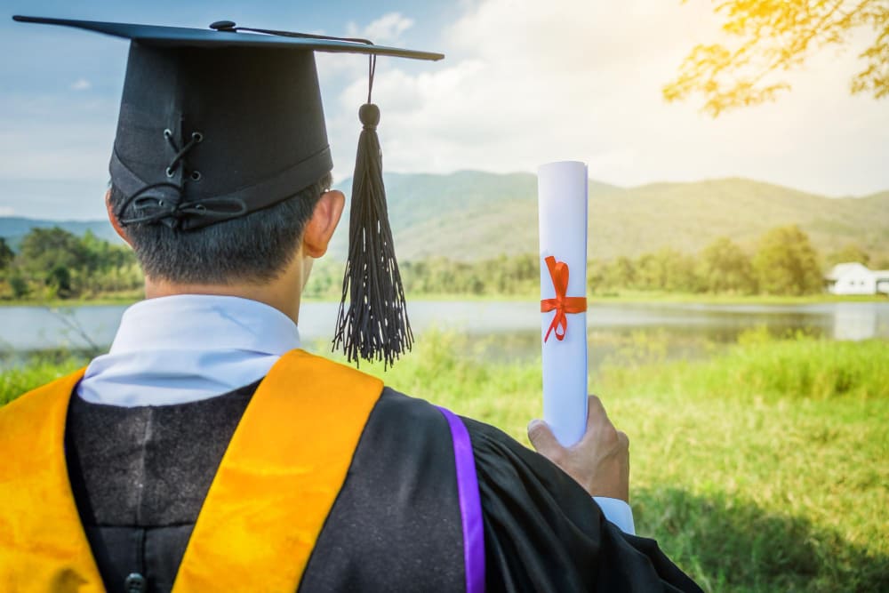 New IRCC Rules: Work Permit and PGWP Changes Every Immigrant Should Know 3 Rear view of man in graduation gown standing outdoors